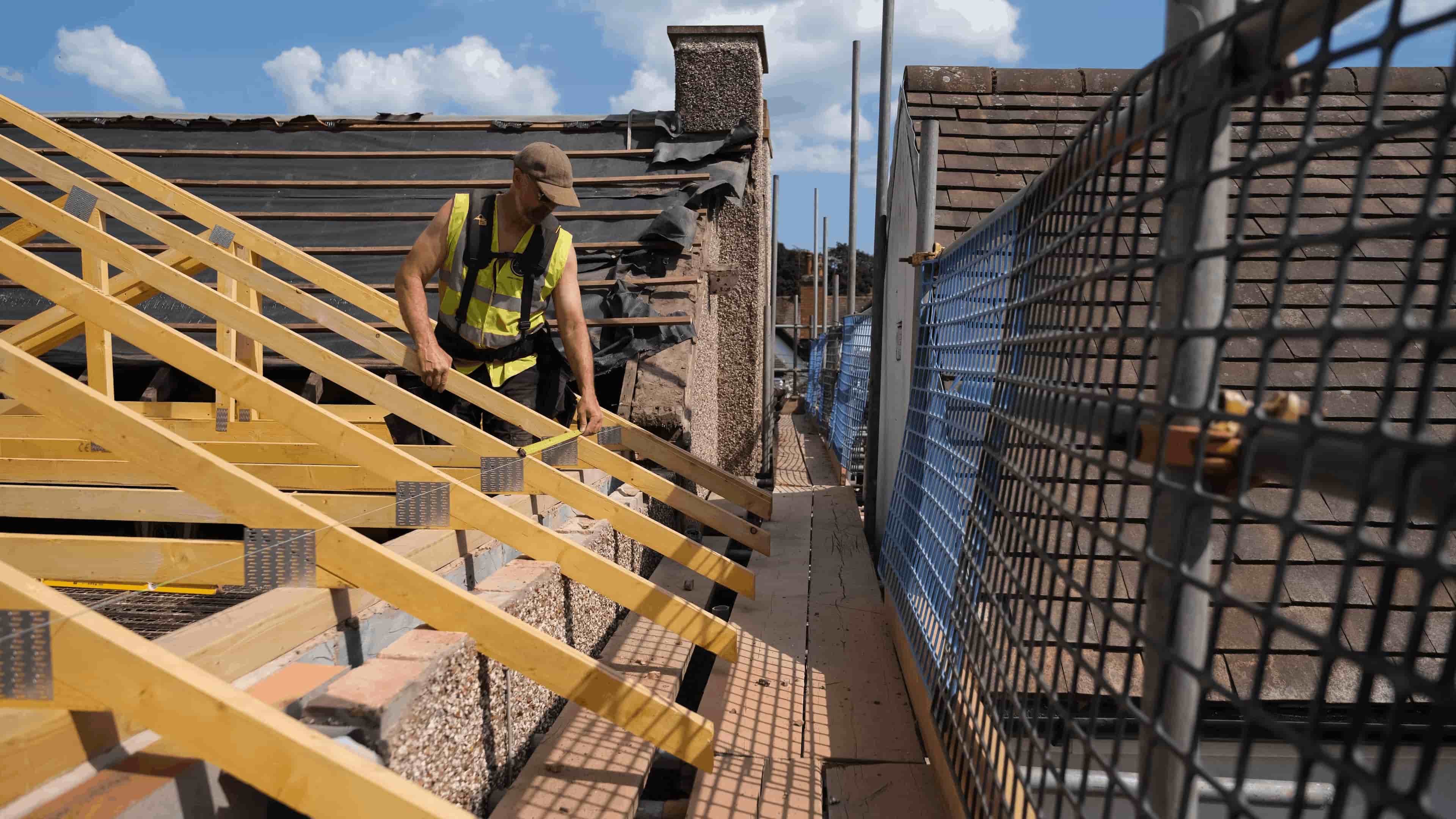 Tradesperson working on a residential roof framework